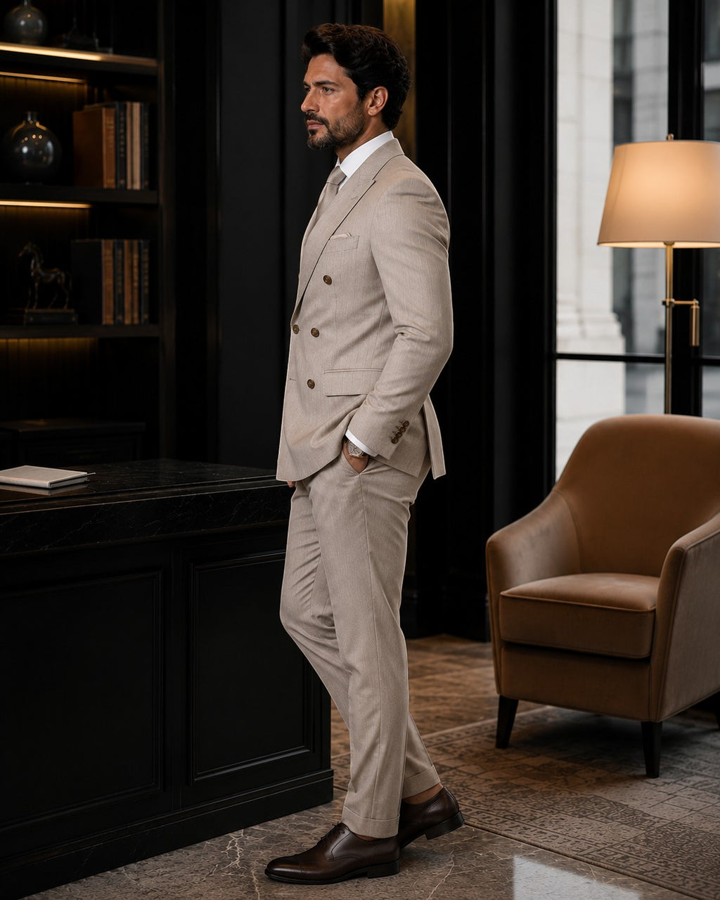 Barutti.ae Marco Ricci beige pinstripe double-breasted suit with peak lapels worn by a man in a luxury office.