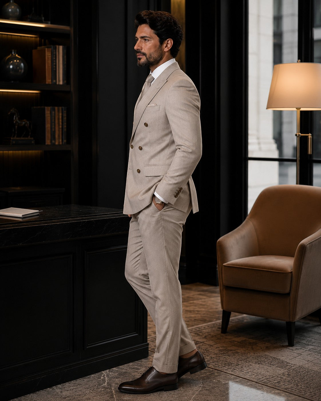 Barutti.ae Marco Ricci beige pinstripe double-breasted suit with peak lapels worn by a man in a luxury office.