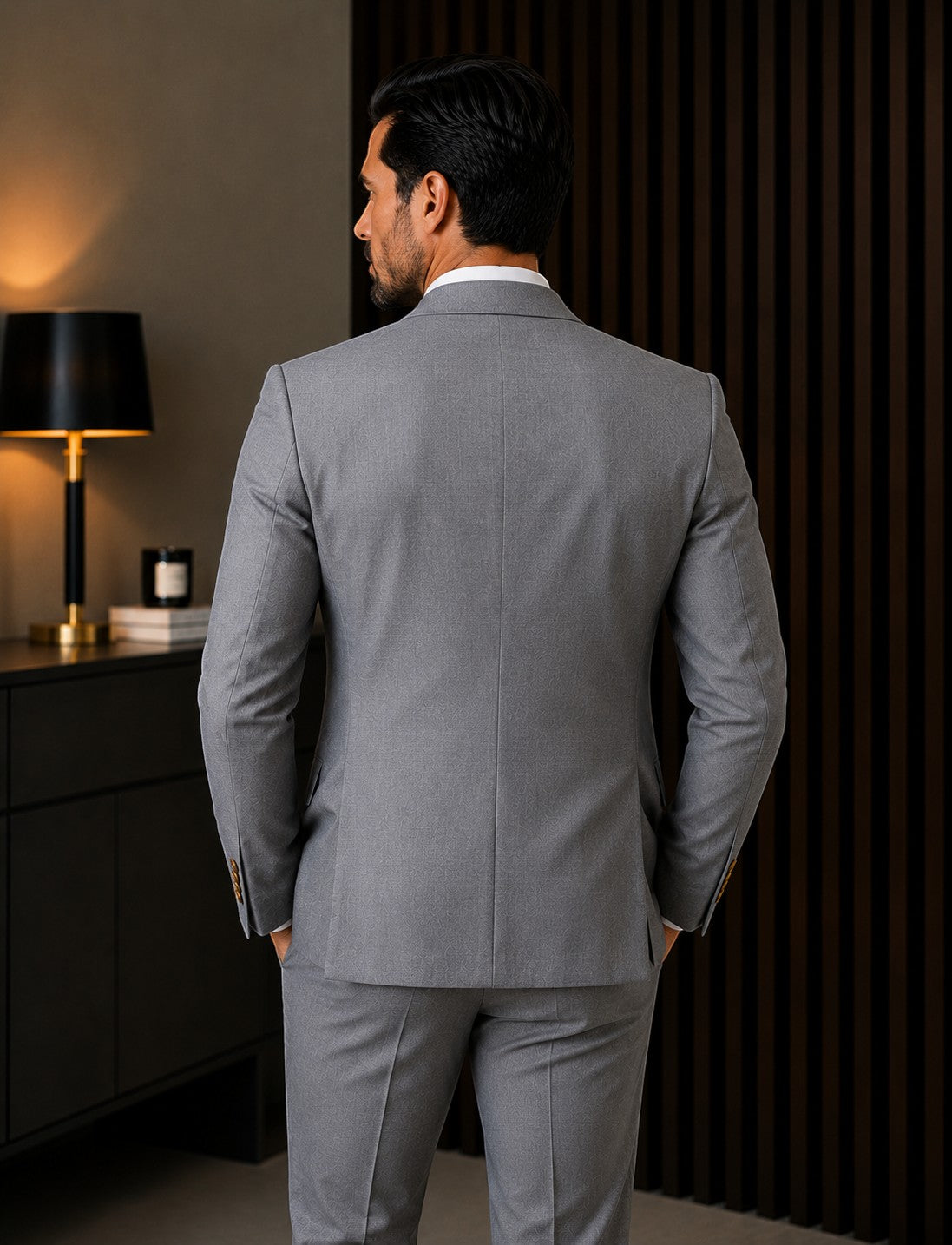 Back view of a man wearing a Barutti.ae mid-grey double-breasted suit with structured shoulders in a formal setting.