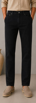 Barutti.ae men's black denim jeans with a classic five-pocket design, worn with a beige shirt and suede loafers.