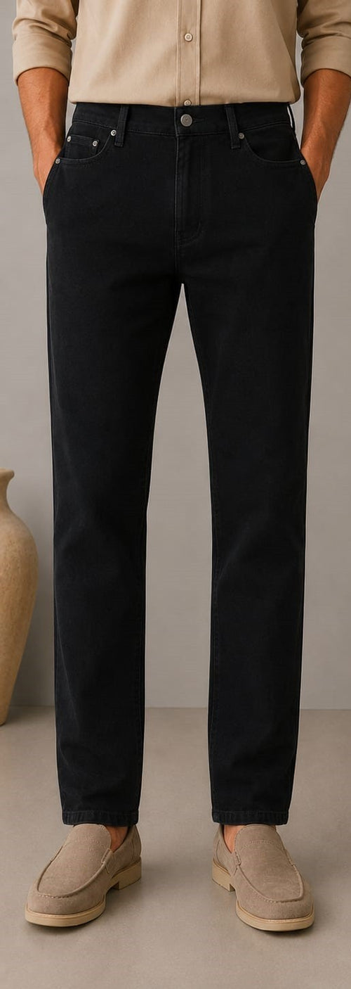 Barutti.ae men's black denim jeans with a classic five-pocket design, worn with a beige shirt and suede loafers.