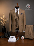 Barutti.ae mustard check three-piece suit on a mannequin with white shirt, brown tie, and black leather shoes.