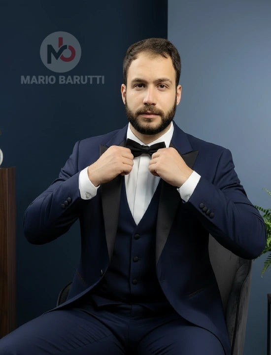 Mario Barutti navy tuxedo with peak lapels and black bow tie worn by a man in a modern tailored fit