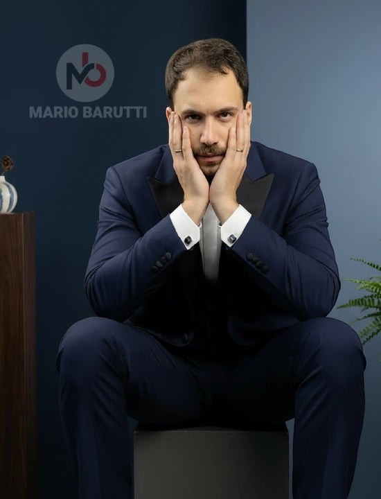 Mario Barutti navy tuxedo with peak lapels worn by a man in a modern fit Super 140 wool suit for black-tie events.
