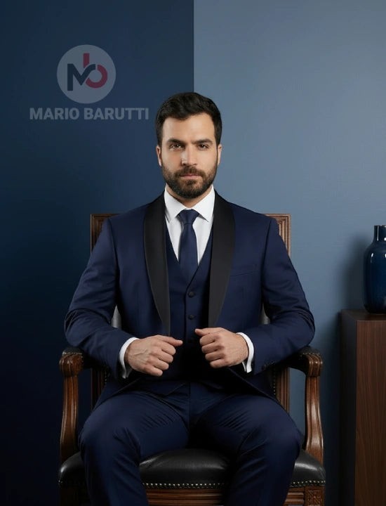 Mario Barutti navy tuxedo with a black shawl lapel and waistcoat worn by a man sitting in a wooden chair.
