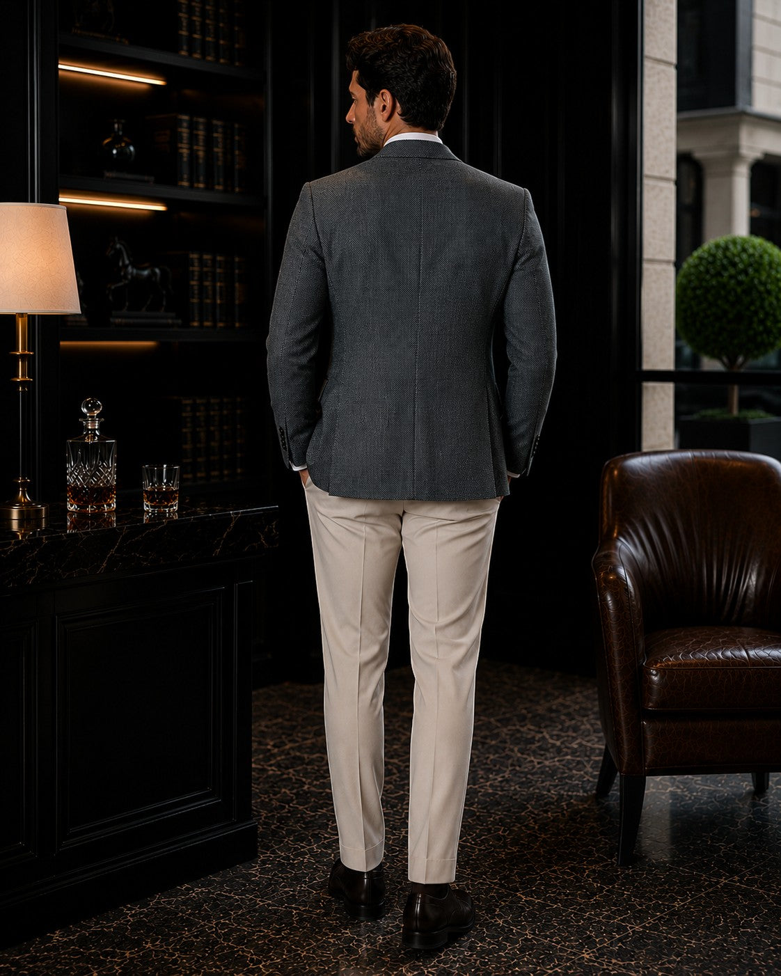 Barutti.ae sage green textured wool blazer worn by a man from the back in a luxury study setting