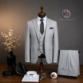 Marco Ricci silver three-piece suit on a mannequin with white shirt, black tie, and matching trousers on a wooden table.