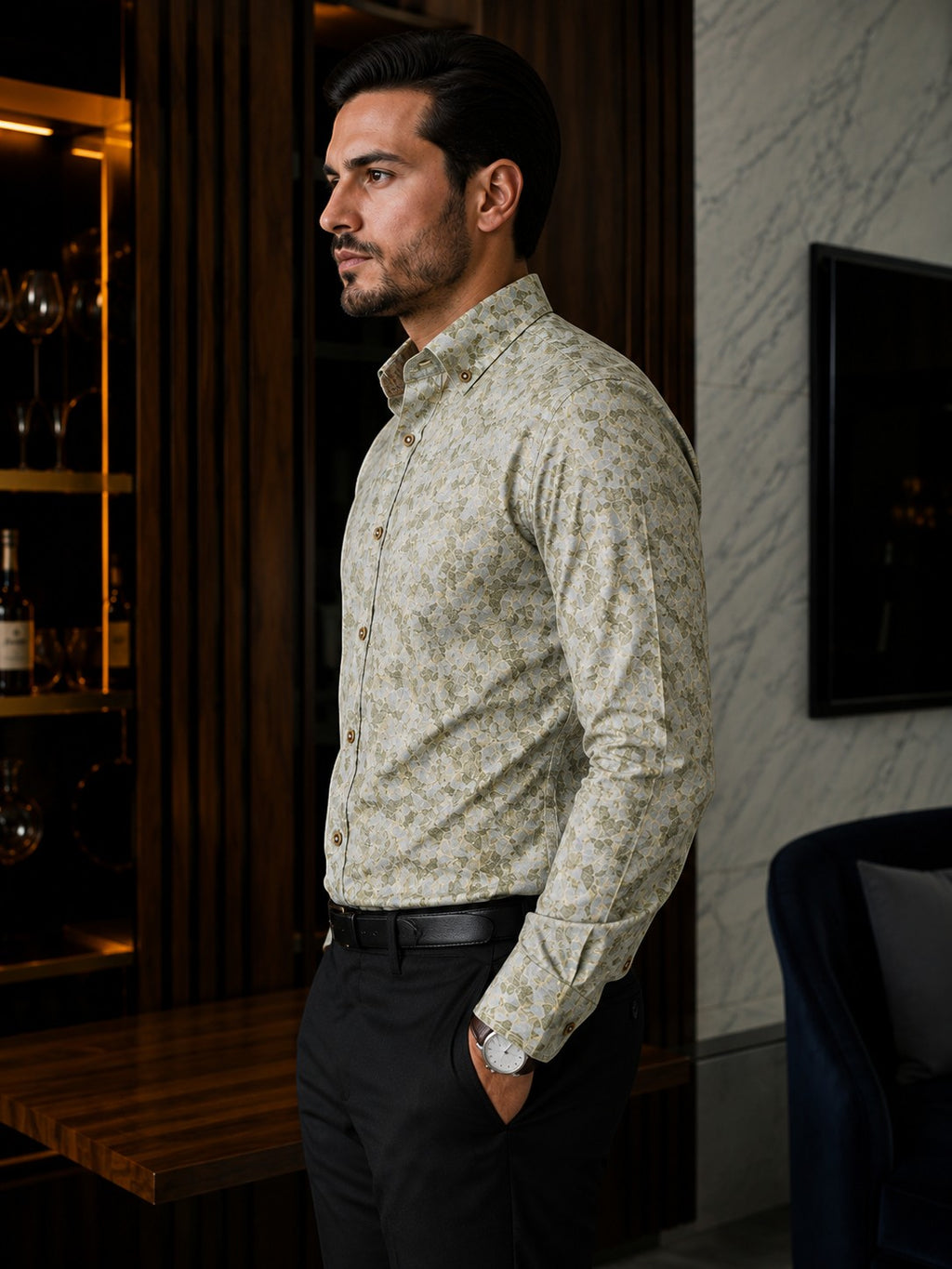 Barutti.ae Venti body-fit shirt in olive and sage leaf print with button-down collar, worn by a man in a modern interior