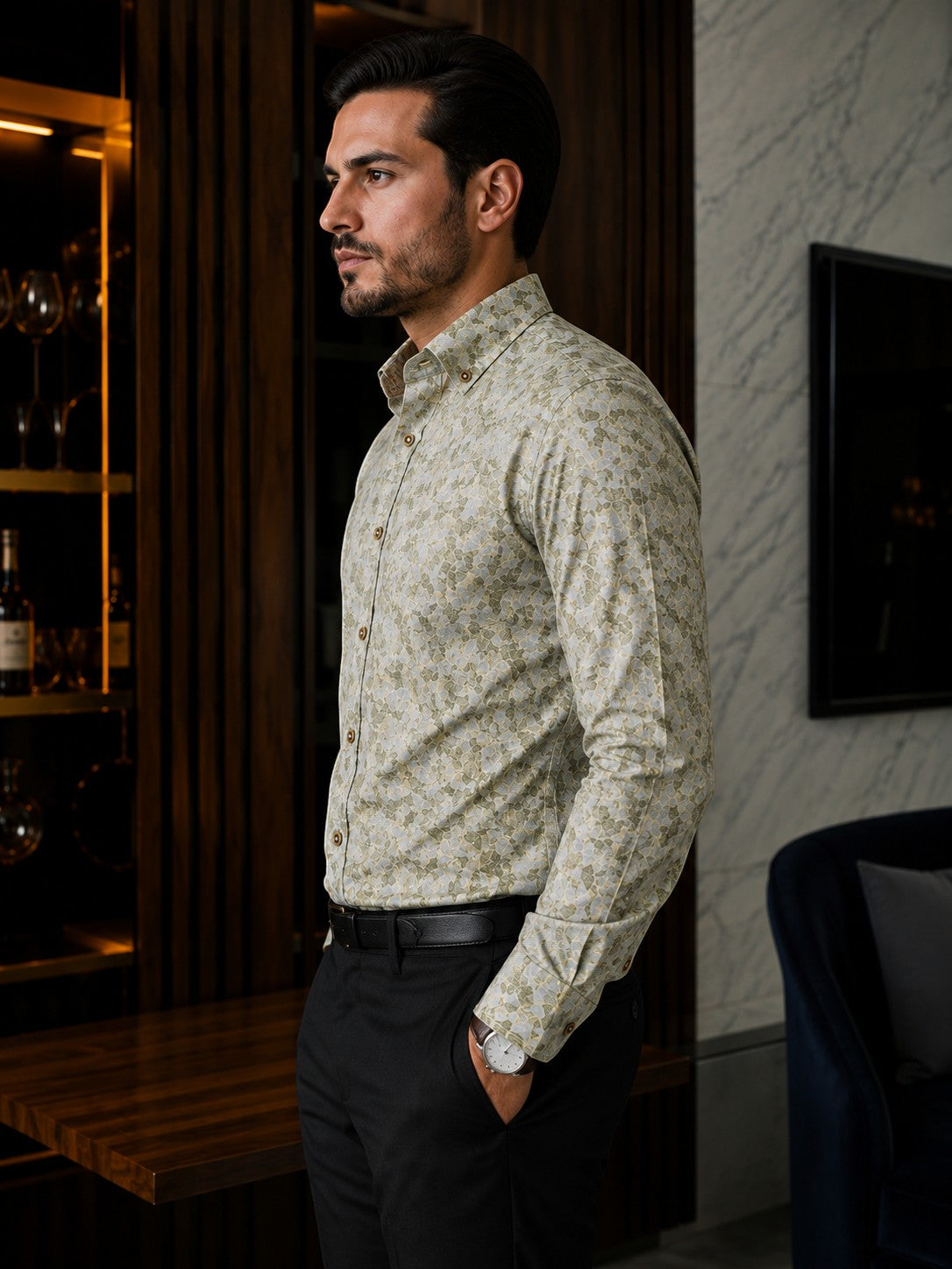 Barutti.ae Venti body-fit shirt in olive and sage leaf print with button-down collar, worn by a man in a modern interior