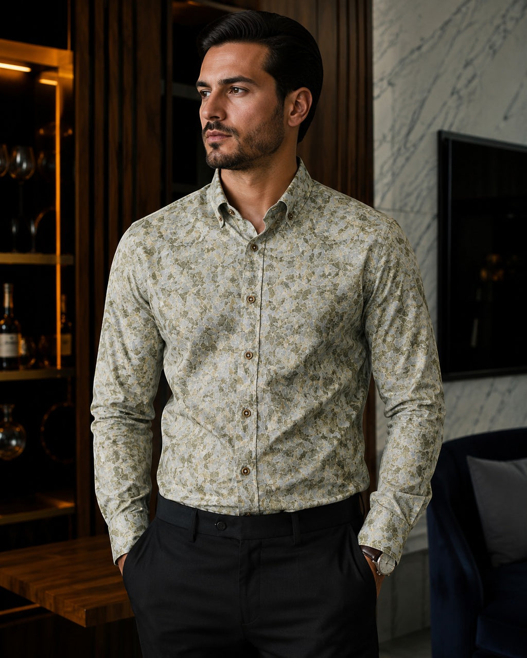 Barutti.ae Venti body-fit shirt in olive and sage leaf print with button-down collar worn by a man in a modern room.