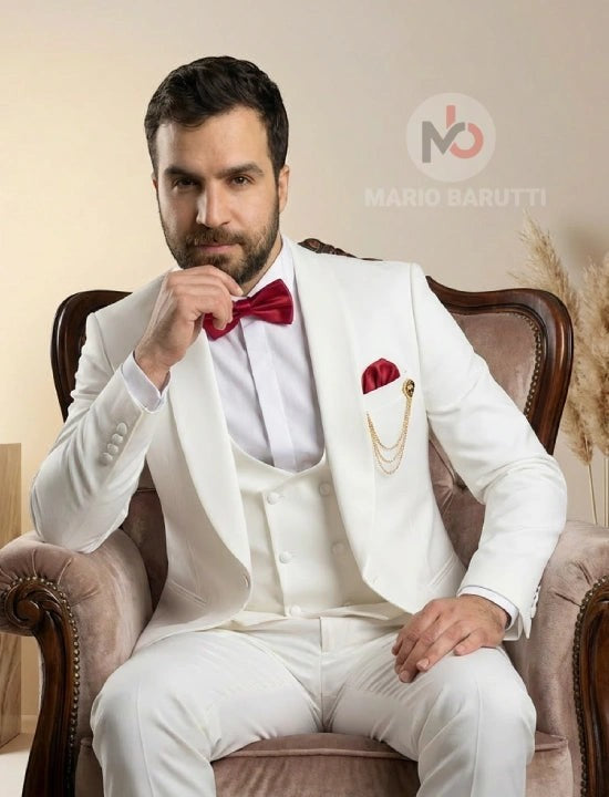 Mario Barutti white tuxedo with shawl lapel, waistcoat, and red bow tie worn by a man sitting in a vintage armchair.