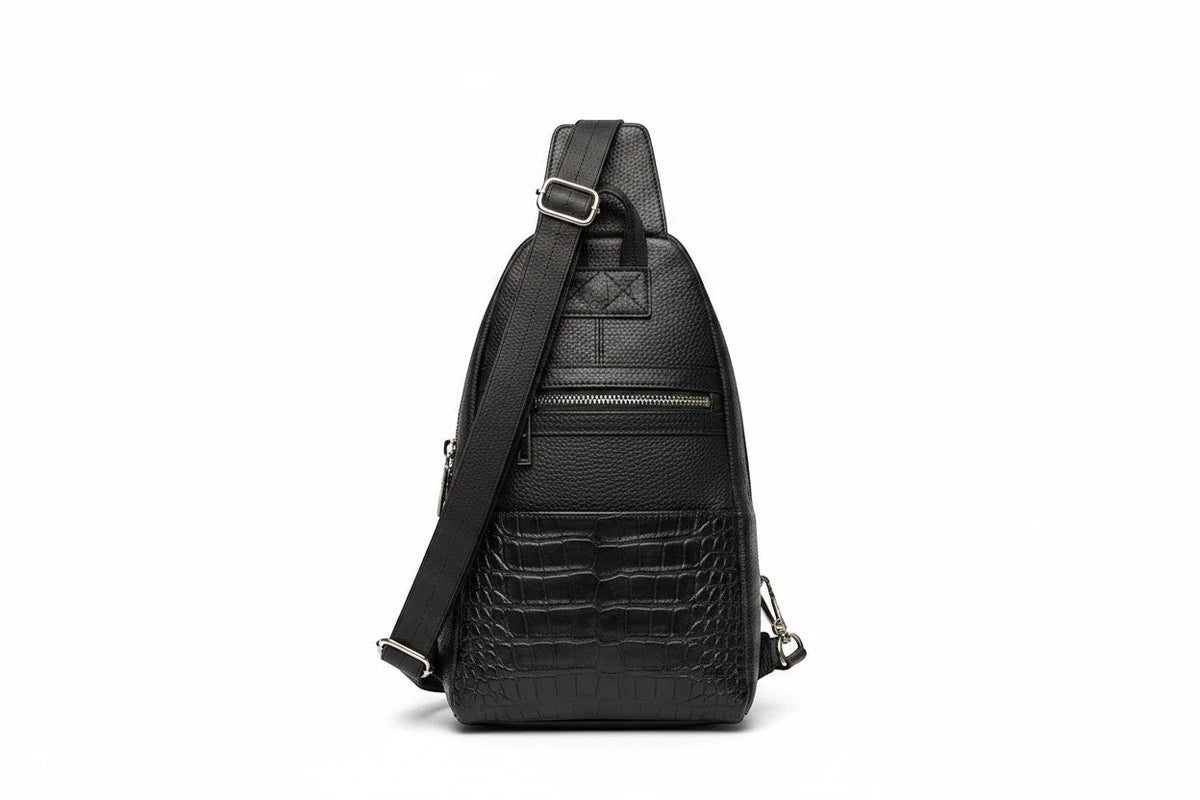 Barutti The Bergamo black leather sling bag with crocodile-embossed front and adjustable strap.