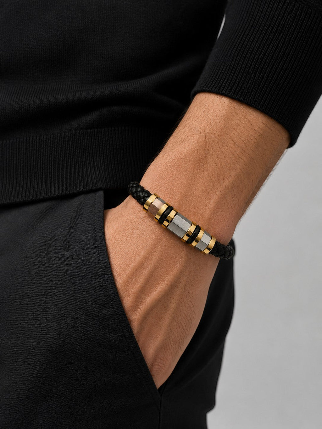 Barutti black braided leather bracelet with brushed stainless steel and gold-tone metal rings.