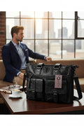 Barutti Brescia black leather holdall bag with front pockets on a table near a man.