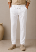Man wearing Mario Barutti white linen drawstring trousers, front view, Mario Barutti Dubai