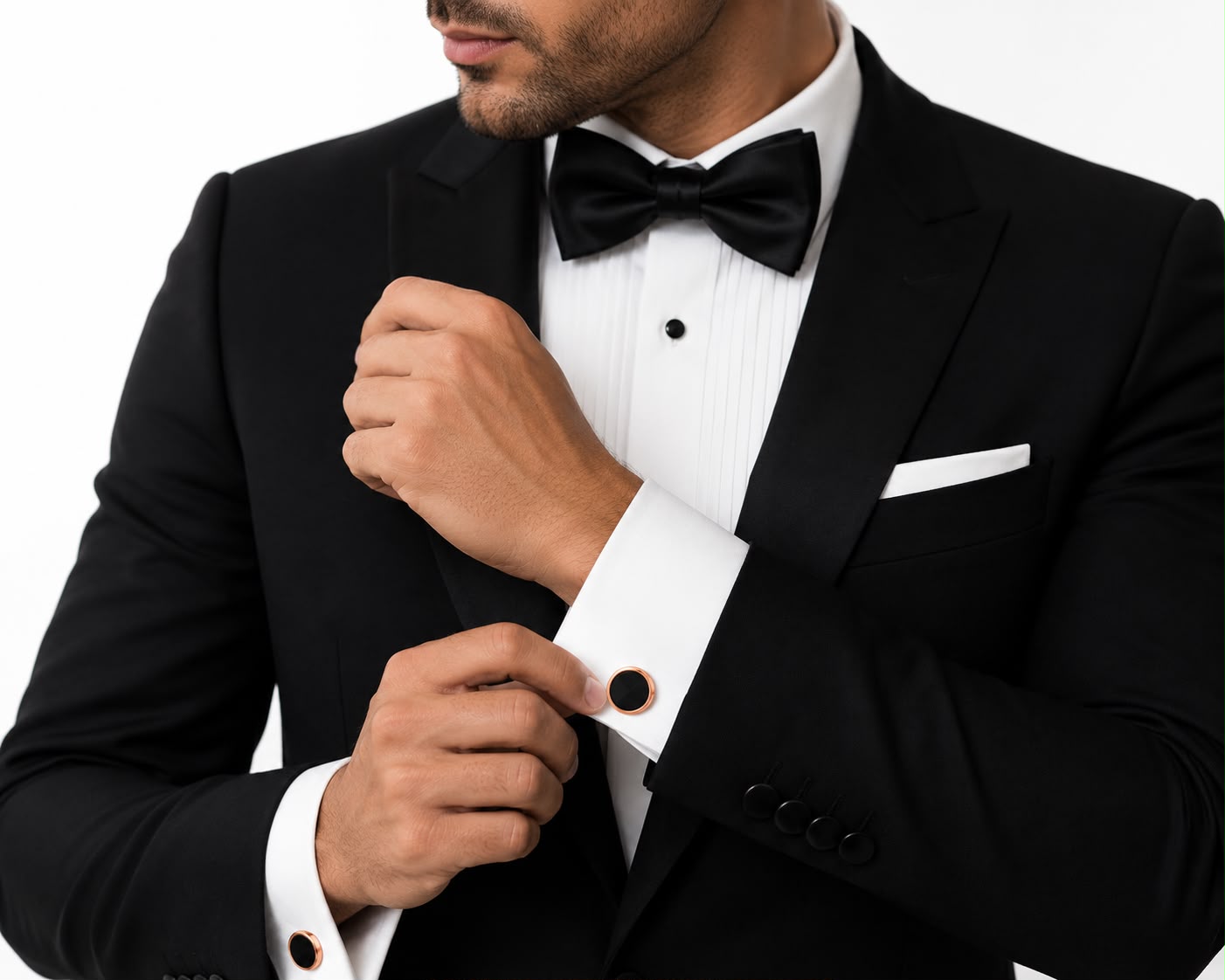 Rose gold and black round cufflinks worn on a French-cuff tuxedo shirt