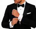 Tortoiseshell-effect and gold crystal round cufflinks worn on a French-cuff tuxedo shirt