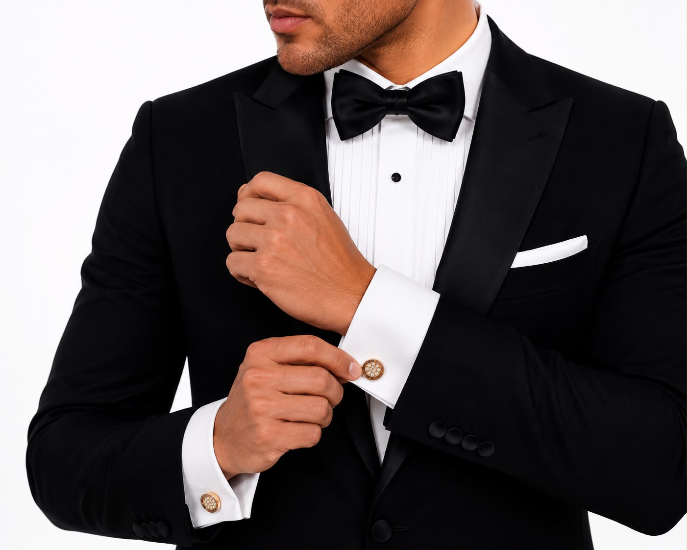 Tortoiseshell-effect and gold crystal round cufflinks worn on a French-cuff tuxedo shirt